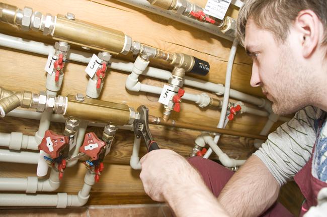 5- Plumber at work. Servicing water & heating systems